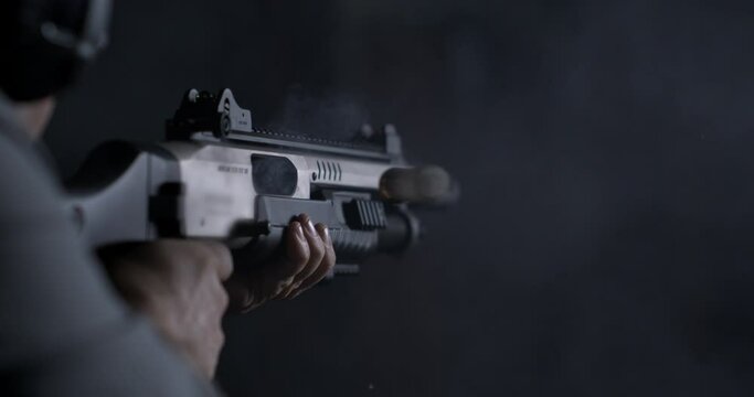 High-Speed 800fps Slow-Motion Speed-Ramp of Man Firing Shotgun, Impactful Shot with Pervasive Smoke