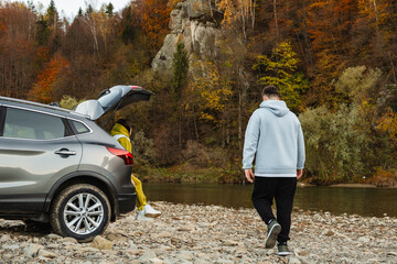 couple road trip travelers resting near mountain river autumn season