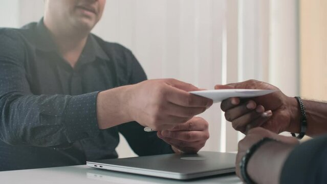 Cropped shot of project manager giving flash card with data and director paying salary for work and shaking hands