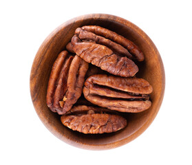 Pecan nuts in wooden bowl, isolated on white background. Shelled pecan. Clipping path. Top view.