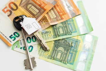 Model of house with keys on euro bills. Close up.