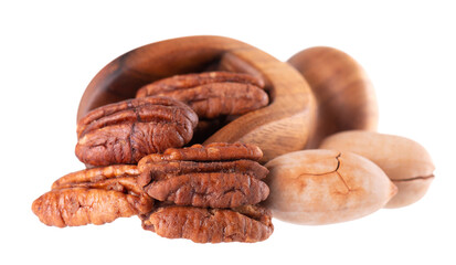 Pecan nuts in wooden scoop, isolated on white background. Shelled and unshelled pecan. Clipping path.