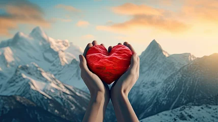 Foto op Canvas a couple's hands clasping a red heart against the backdrop of majestic mountain peaks, emphasizing the strength and endurance of their love. © lililia