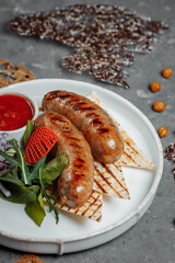 Grilled tasty bratwurst sausages on the plate