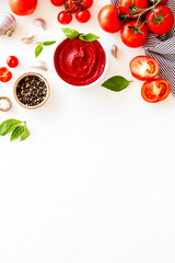 Tomato sauce passata in bowl with fresh tomatoes and basil