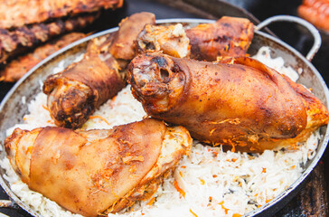 The meat is fried in a frying pan on the grill