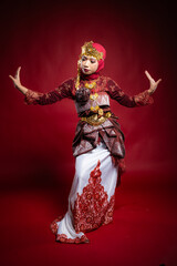 An Asian female traditional damcer wearing a traditional apparel and accessories dancing the traditional dance
