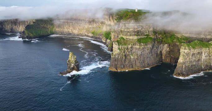 Aerial of coastal cliffs Moher shrouded in low clouds 4k