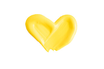 Yellow color paint heart shape texture isolated on white background. Yellow creamy swatch, macro. Cosmetic beauty product sample. Beautiful textured golden yellow stroke. Yellow paint smear