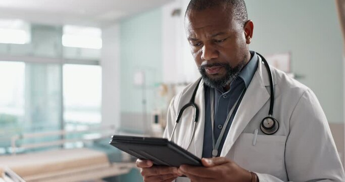 Healthcare, black man and doctor with a tablet, internet or connection with online reading, digital app or check results. Person, employee or medical professional with tech, research and internet - Powered by Adobe
