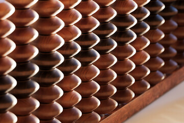 A vintage wooden abacus with beads and metal wire, perfect for counting