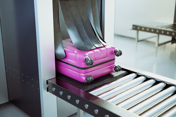 A pink suitcase exiting an airport scanner on a conveyor belt. Security check - obrazy, fototapety, plakaty