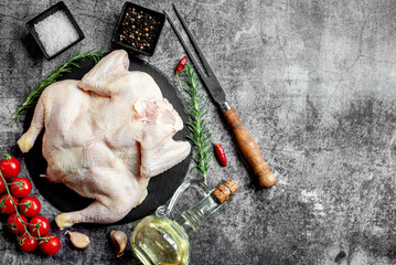 whole raw chicken on a stone background with copy space for your text