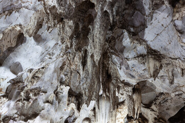 Inside Muang On Cave in Northern Thailand, sunlight reveals the beauty of stalactites and...