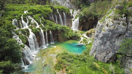 Beautiful waterfall in green forest, aerial top down view. Summer mountain landscape. Famous...