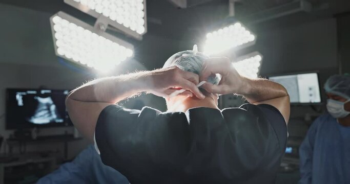 Surgery, prepare and doctor tie mask in operating room for medical service, protection and operation. Healthcare team, safety scrubs and person with uniform for emergency, procedure and wellness