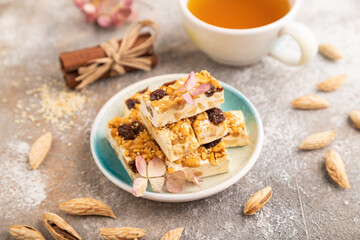 Traditional candy nougat with nuts and sesame, side view, selective focus.