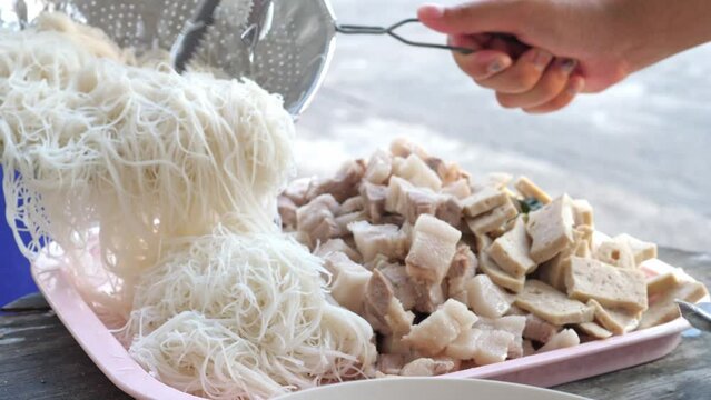 Boiled pork belly cut into pieces Pork sausage, a traditional Thai food, and boiled white rice noodles are all prepared to make the menu ''Miang Pork Belly'' a famous Thai spicy food.
