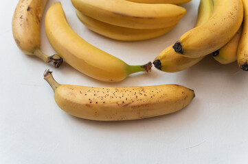 Sweet Ripe yellow fruit bananas on table. Isolated white background. Healthy tropical food