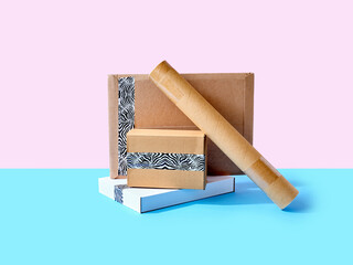Stack of cardboard parcels packed with zebra patterned tape on colorful background
