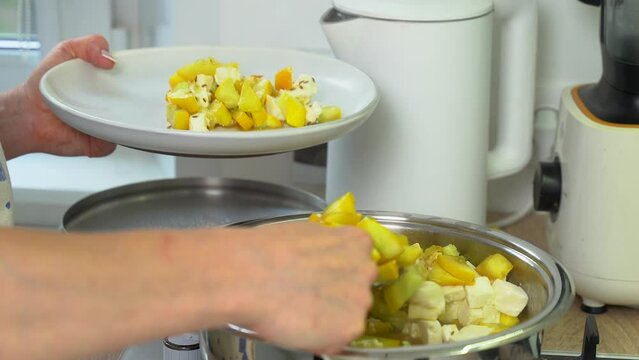 A woman puts a dietary dish made from zucchini and feta cheese on a plate. Close-up. Keto diet.