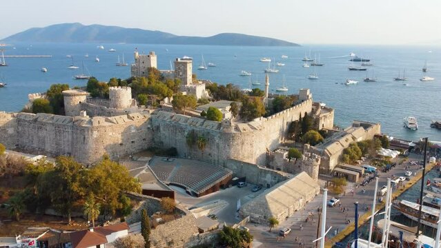 Castle of St. Peter Bodrum Marina, sailing boats and yachts in Bodrum, Turkey. Windsurfer Surfing Wind On Waves - Saint Peter Castle (Bodrum castle) and marina in Bodrum, Turkey