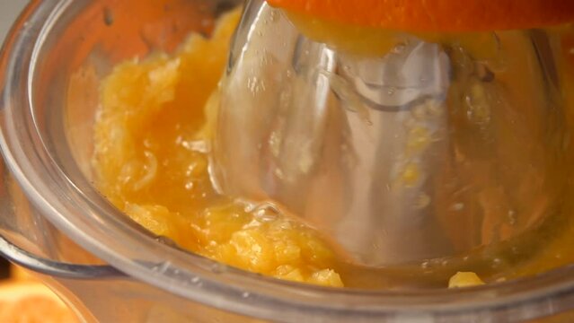 Close-up of the orange juice squizzed from the half of an orange