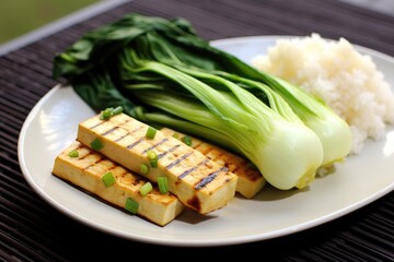 plate of grilled tofu with a side of steamed bok choy - obrazy, fototapety, plakaty
