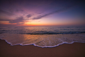 Beautiful cloudscape over the sea wave and beach shore, scenic sunrise ocean landscape