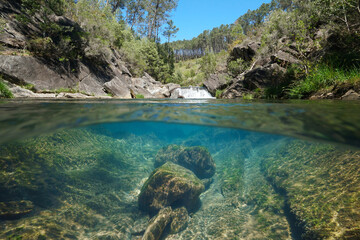 Fototapeta na wymiar Waterfall on a wild river with clear water, natural scene, split level view over and under water surface, Spain, Galicia, Pontevedra province