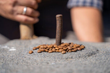 Obraz na płótnie Canvas Coffee beans in a traditional stone mill.