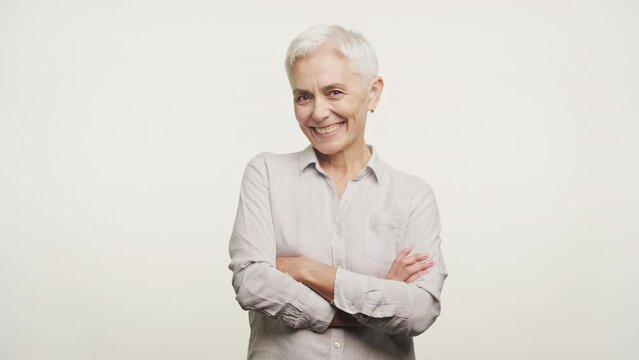 Mature Woman Smiling Looking At Camera on White Background