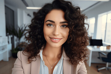 Successful young attractive businesswoman working at her workstation in the office