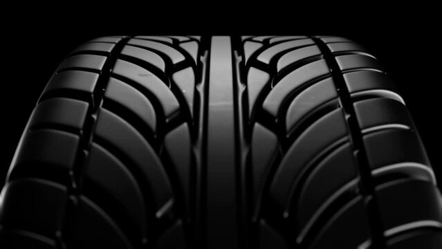 Close up on a black car tire in motion. Loop animation.