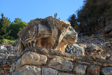 The top of a column capital of the Ionic order on the ruins of the ancient city of Ephesus