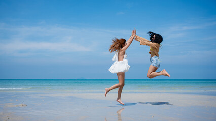 Happy girls enjoying freedom and walking on the beach., Summer holidays and vacation concept..