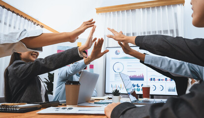 Diverse business team celebrate successful meeting with high-fives and expressions of happiness in corporate office meeting represent unity success and professional integrity. Concord - obrazy, fototapety, plakaty