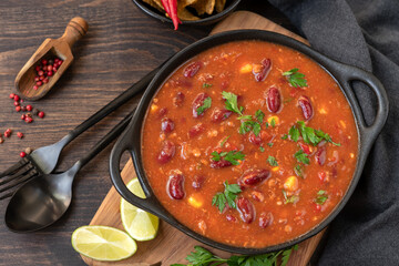 Bean and corn soup or ragout, red bean stew on a wooden background. Food Protein Vegan dish