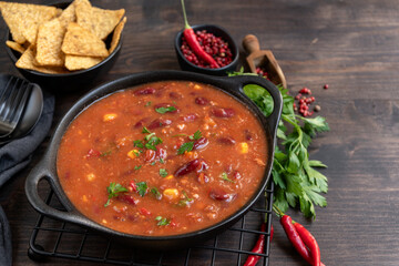 Bean and corn soup or ragout, red bean stew on a wooden background. Food Protein Vegan dish