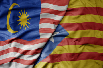big waving realistic national colorful flag of malaysia and national flag of catalonia .