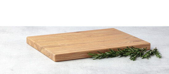 Cutting board and rosemary on a grey stone table.