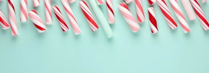 Foto op Aluminium White and red shiny Christmas candy canes, minimal flat lay pattern background. © Premium_art