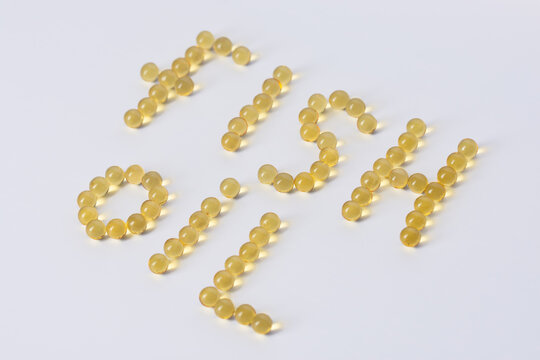 Fish Oil In Round Capsules On A White Background