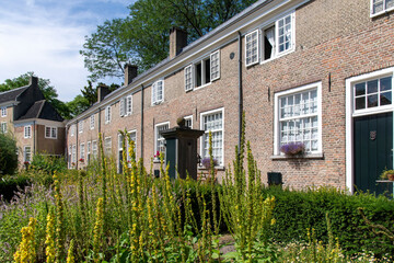 Courtyard of the beguinage (Begijnhof) in Breda, the Netherlands with herb garden and surrounded by 29 small houses 