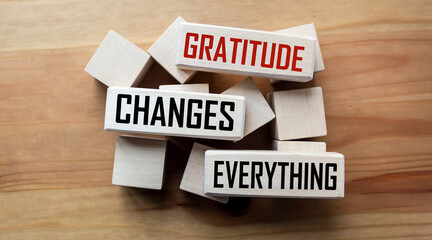 Gratitude changes everything word written on wood block. Gratitude changes everything text on...