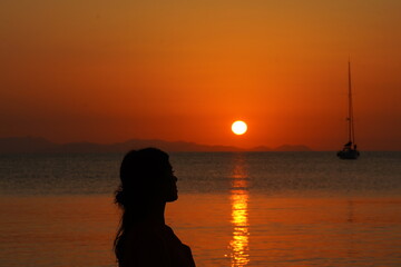Silhouette Profile of a Woman Watching the Sunrise over the Sea