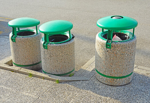 Three concrete dumpsters