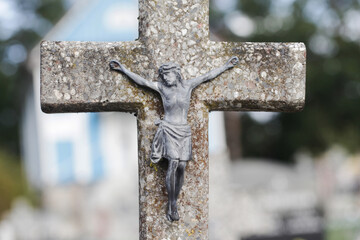 Jesus crucified metal statue. Weathered concrete cross. Graveyard background. Rusty grunge symbol....
