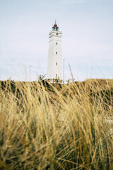 lighthouse on coastline in blavand denmark