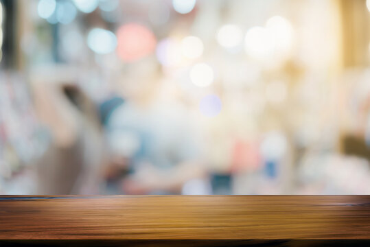 Empty wooden table top with lights bokeh on blur background.